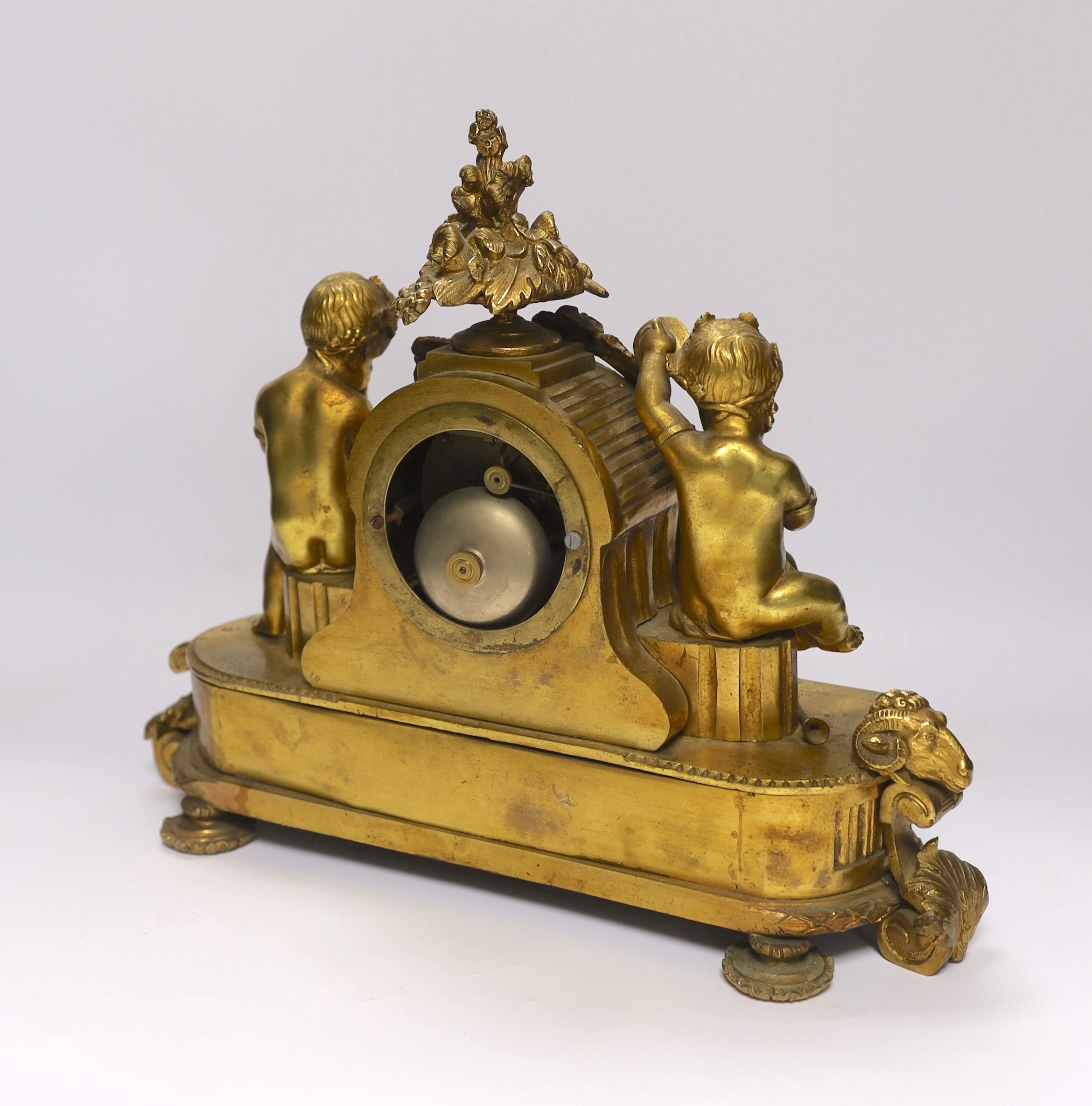 A late 19th century French ormolu mantel clock surmounted with cherubs, 31cm